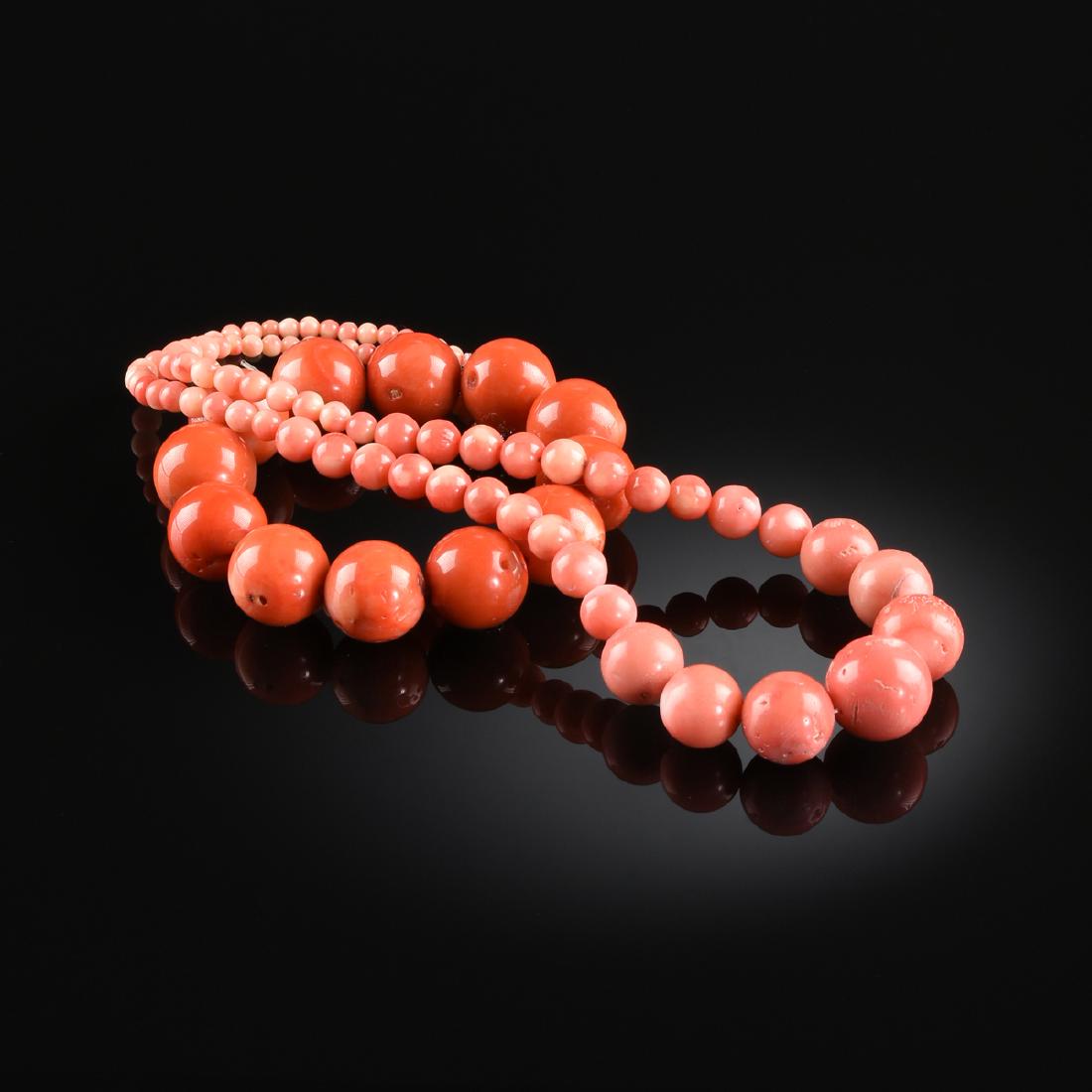 A PINK CORAL LADY'S NECKLACE, 20TH CENTURY,: A PINK CORAL LADY'S NECKLACE, 20TH CENTURY, the eighty-three beads each carved in globular form, graduating in size from 3 millimeters to 15.8 millimeters, with a lobster claw clasp, total approximate