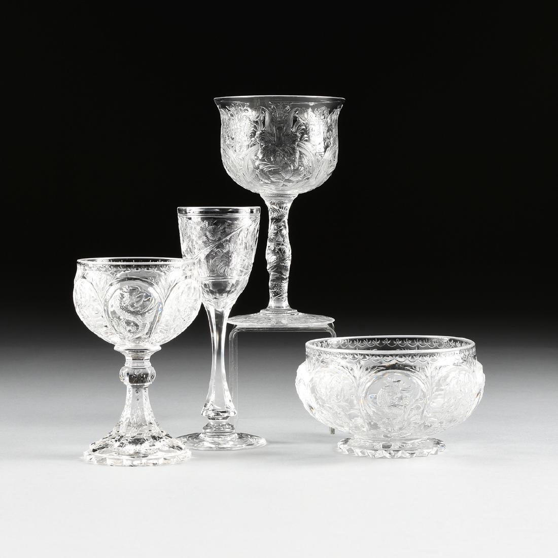 A GROUP OF FOUR ENGLISH AND AMERICAN BRILLIANT CUT: A GROUP OF FOUR ENGLISH AND AMERICAN BRILLIANT CUT CRYSTAL VESSELS, CIRCA 1890-1905, comprising a Thomas Webb & Corbett Ltd. pressed and cut "rock crystal" "Dragon" pattern wine glass from the Elbert