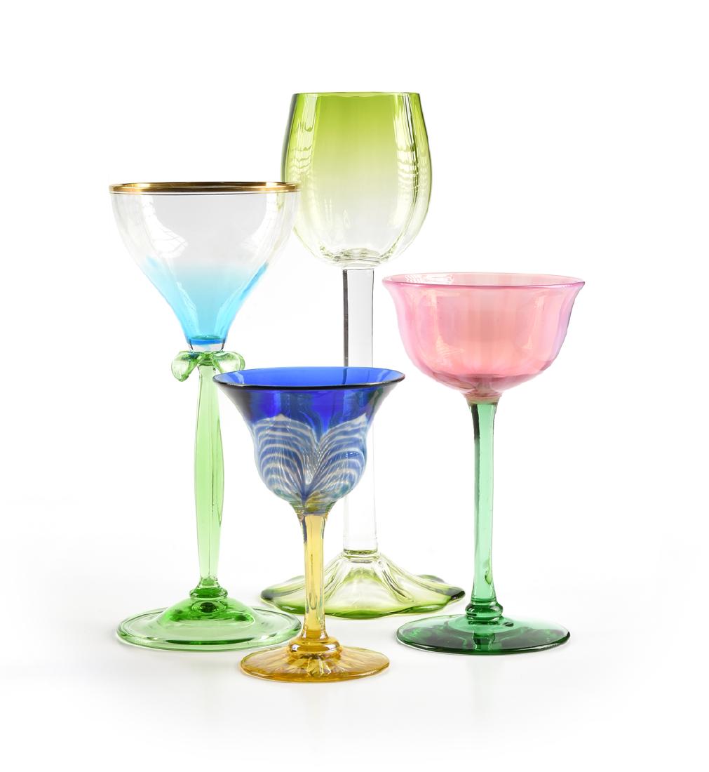A GROUP OF FOUR AMERICAN AND BOHEMIAN WINE GLASSES,: A GROUP OF FOUR AMERICAN AND BOHEMIAN WINE GLASSES, CIRCA 1890-1910, comprising a Bohemian flashed optic wine glass, the faceted bell form bowl in blue to clear raised on green baluster form stem with