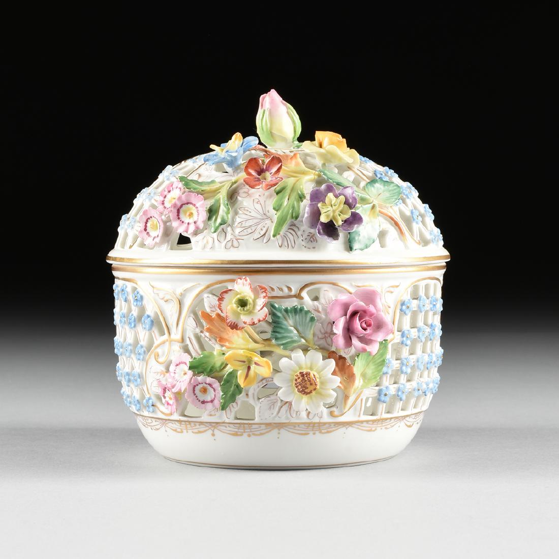 A CARL THIEME SACHSISCHE PORZELLANFABRIK GILT AND: A CARL THIEME SACHSISCHE PORZELLANFABRIK GILT AND ENAMEL DECORATED RETICULATED BOWL WITH COVER, POTSCHAPPEL, GERMANY, CIRCA 1902-1918, the reticulated top and sides adorned with applied flower blossom