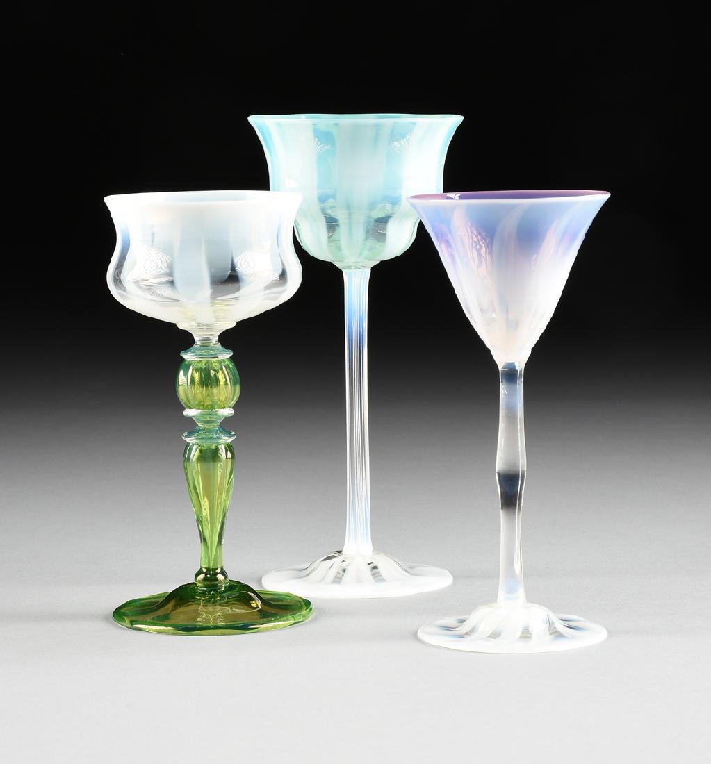 LOUIS COMFORT TIFFANY (American 1848-1933) A GROUP OF: LOUIS COMFORT TIFFANY (American 1848-1933) A GROUP OF THREE PASTEL FAVRILE GLASS VESSELS, FOR TIFFANY STUDIOS, CORONA, QUEENS, NEW YORK, CIRCA 1920-1930, comprising a wine goblet with white/gold iride