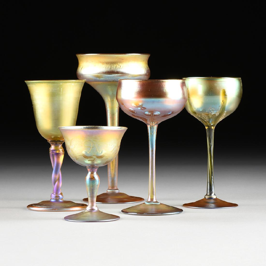 LOUIS COMFORT TIFFANY (American 1848-1933) A GROUP OF: LOUIS COMFORT TIFFANY (American 1848-1933) A GROUP OF FIVE FAVRILE GLASS VESSELS, FOR TIFFANY STUDIOS, CORONA, QUEENS, NEW YORK, CIRCA 1895-1933, comprising a wine stem with bell form bowl raised on t