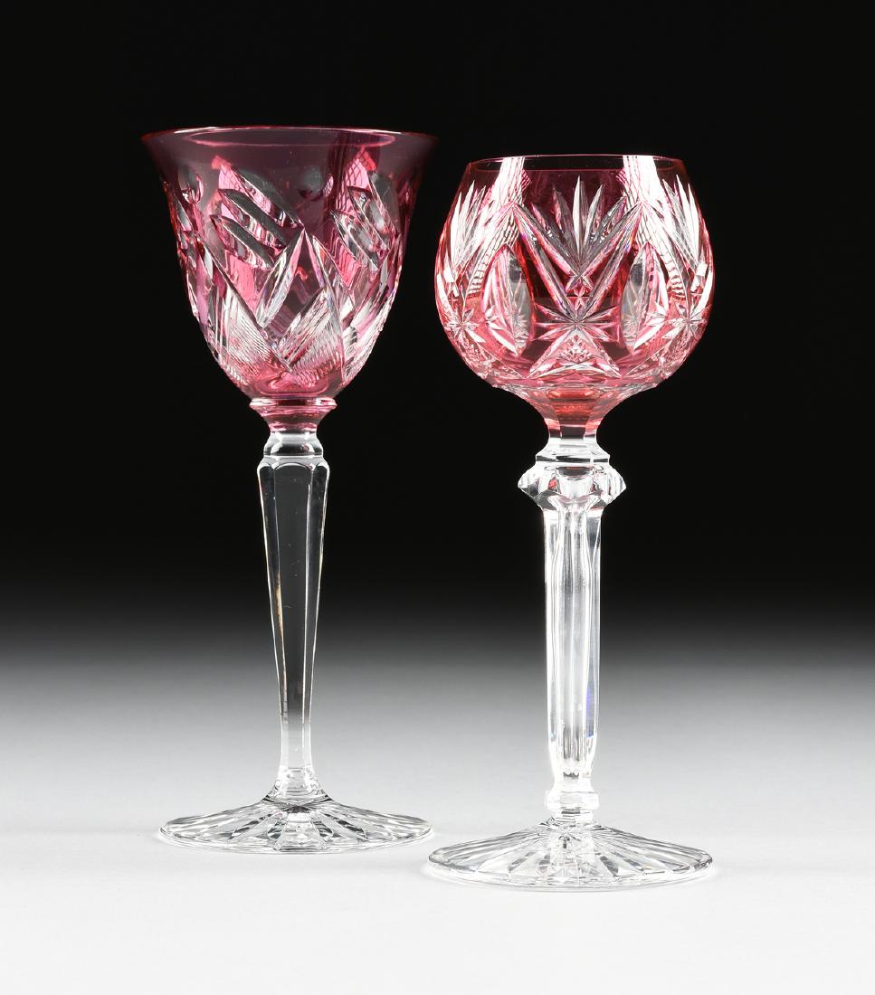 A GROUP OF TWO CONTINENTAL CRANBERRY CUT TO CLEAR WINE: A GROUP OF TWO CONTINENTAL CRANBERRY CUT TO CLEAR WINE GLASSES, CIRCA 1900-1920, comprising a double cased wine Hock with bell form bowl raised on a clear faceted baluster form stem, the spreading foo