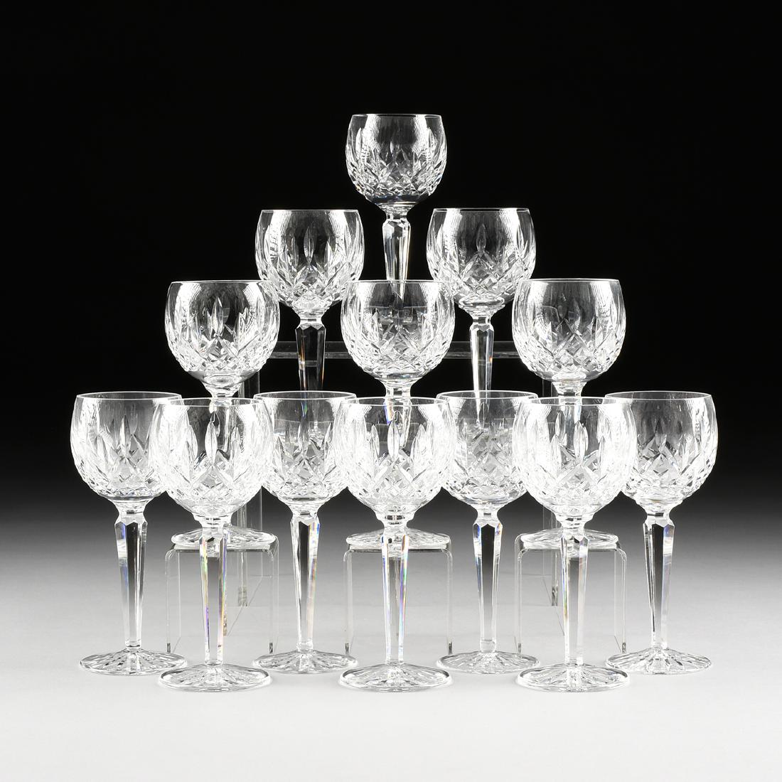 A SET OF THIRTEEN WATERFORD CLEAR CUT CRYSTAL BALLOON: A SET OF THIRTEEN WATERFORD CLEAR CUT CRYSTAL BALLOON WINE GLASSES IN THE "LISMORE" PATTERN, IRELAND, DESIGNED 1957, the globular bowl cut with staggered verticals over criss-cross cuts, raised on fac