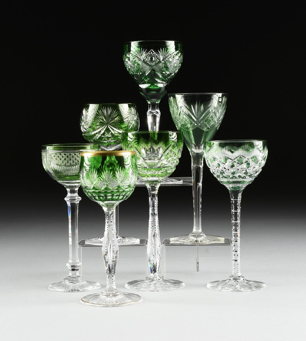 A GROUP OF SEVEN CONTINENTAL GREEN CUT TO CLEAR WINE: A GROUP OF SEVEN CONTINENTAL GREEN CUT TO CLEAR WINE GLASSES, CIRCA 1900-1930, comprising a German or Bohemian Rhine wine glass, raised on clear faceted baluster form stem, the spreading foot cut to t