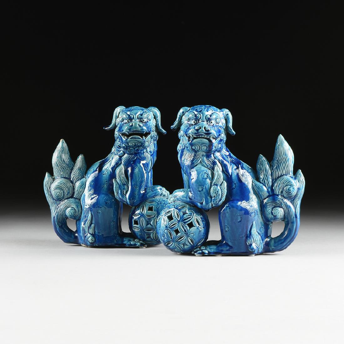 A PAIR OF BLUE GLAZED EARTHENWARE SHISHI GUARDIAN: A PAIR OF BLUE GLAZED EARTHENWARE SHISHI GUARDIAN LIONS, JAPANESE, MEIJI PERIOD (1868-1912), each with turquoise glaze over carved pinwheel fur, reticulated balls and flaming tails. Height: 9 1/2" Wid