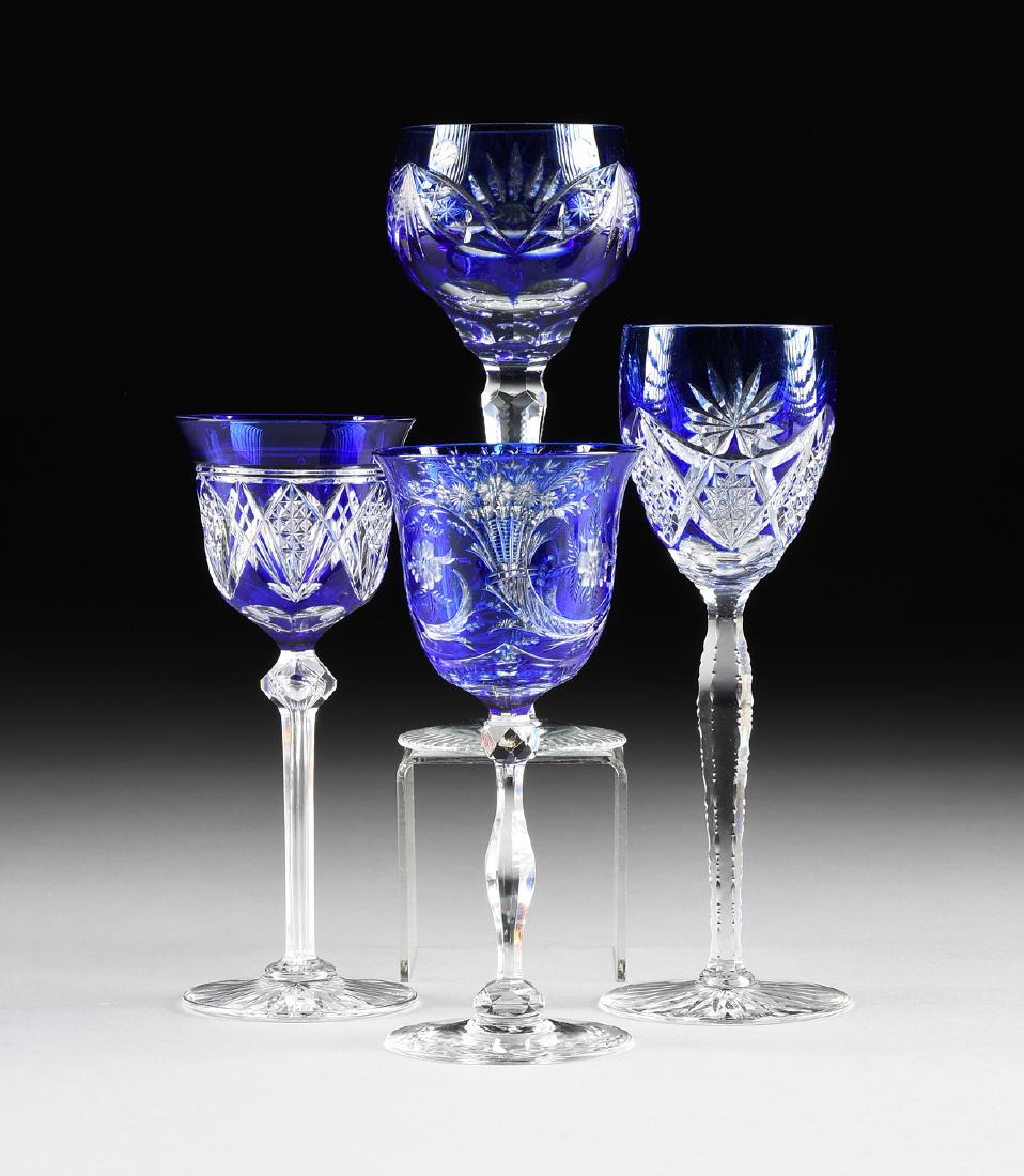 A GROUP OF FOUR CONTINENTAL COBALT CASED AND CUT TO: A GROUP OF FOUR CONTINENTAL COBALT CASED AND CUT TO CLEAR WINE GLASSES, CIRCA 1880-1940, comprising a Val St. Lambert wine glass, the bell form bowl raised on a faceted tapering clear glass stem with 
