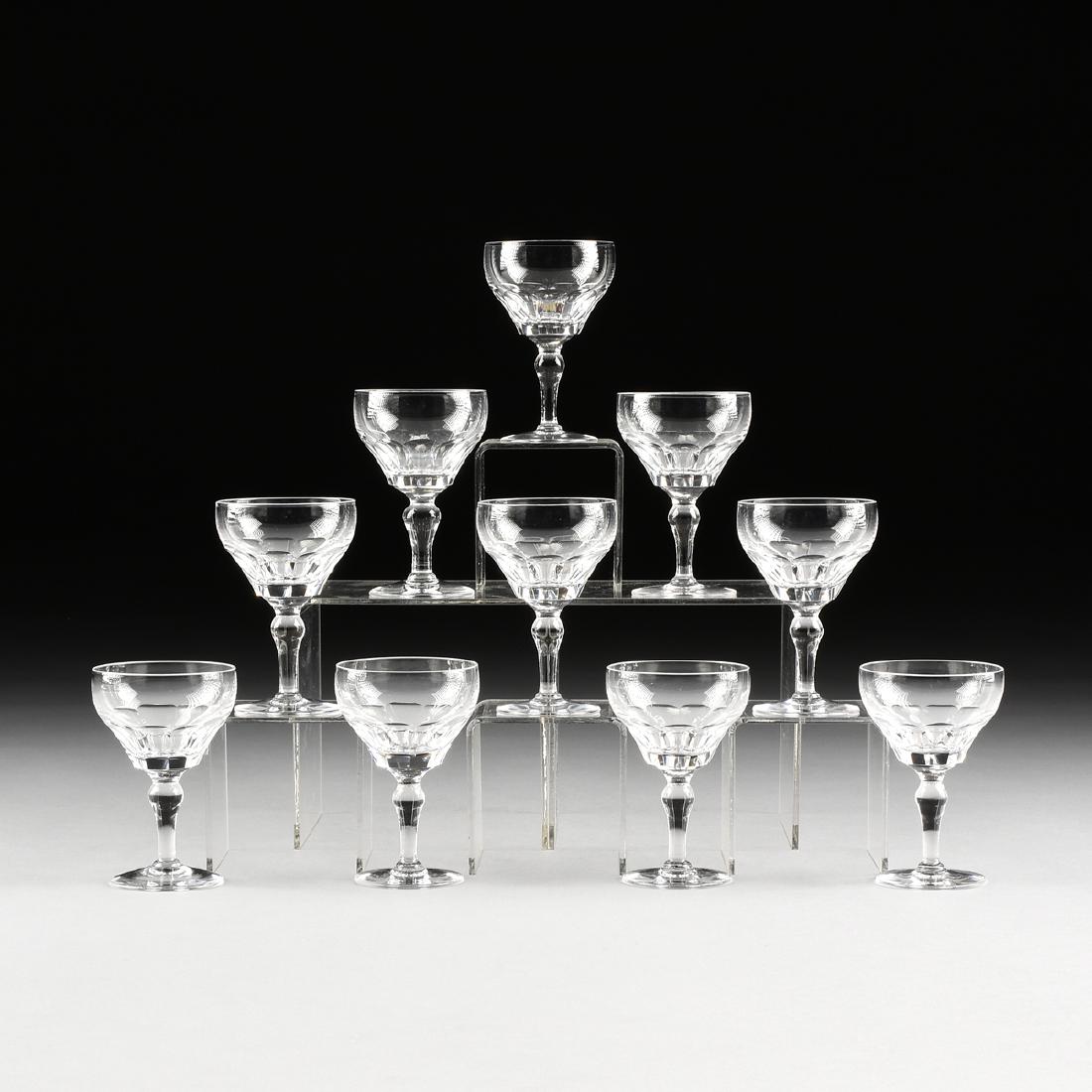 A SET OF TEN STUART CRYSTAL CLARET WINE GLASSES IN THE: A SET OF TEN STUART CRYSTAL CLARET WINE GLASSES IN THE "DORSET" PATTERN, STOURBRIDGE, ENGLAND, CIRCA 1955-1964, the bell form bowl with slice cuts surrounding the base raised on baluster form stem wit