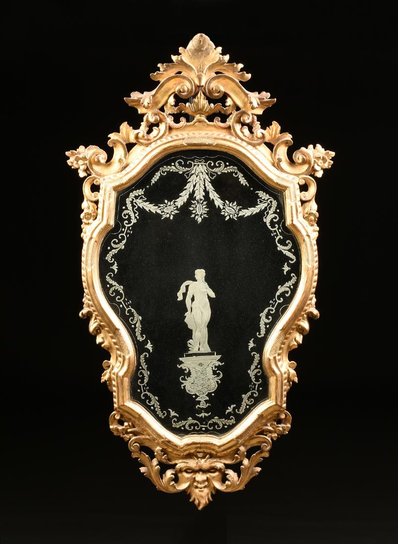 A VENETIAN ROCOCO REVIVAL GILT PINE ACID ETCHED MIRROR,: A VENETIAN ROCOCO REVIVAL GILT PINE ACID ETCHED MIRROR, ITALIAN, MID 19TH CENTURY, the adorsed scroll and acanthus leaf, arched crest, issuing "C" scrolls, flower blooms and leafy flourishes, on a mol