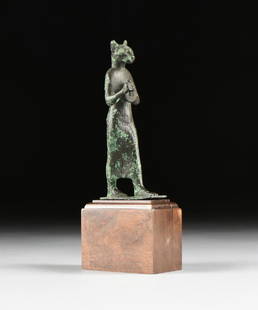 AN ANCIENT EGYPTIAN STYLE BRONZE FIGURE OF WALKING: AN ANCIENT EGYPTIAN STYLE BRONZE FIGURE OF WALKING GODDESS BAST/BASTET, POSSIBLY LATE PERIOD (664-332), the ears with chased hairs, over a cat face with whiskers, the figure stands facing forward, ext