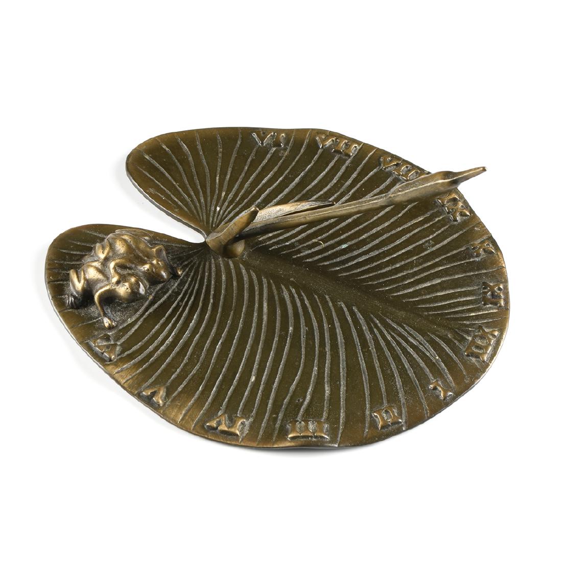 A PATINATED BRONZE LILLY PAD AND FROG SUNDIAL, LATE: A PATINATED BRONZE LILLY PAD AND FROG SUNDIAL, LATE 20TH CENTURY, attributed to White Swan Ltd., the cattail hand over Roman numerals, with two huddled frog figures attached. Height: 4 1/4" Width: 6 3
