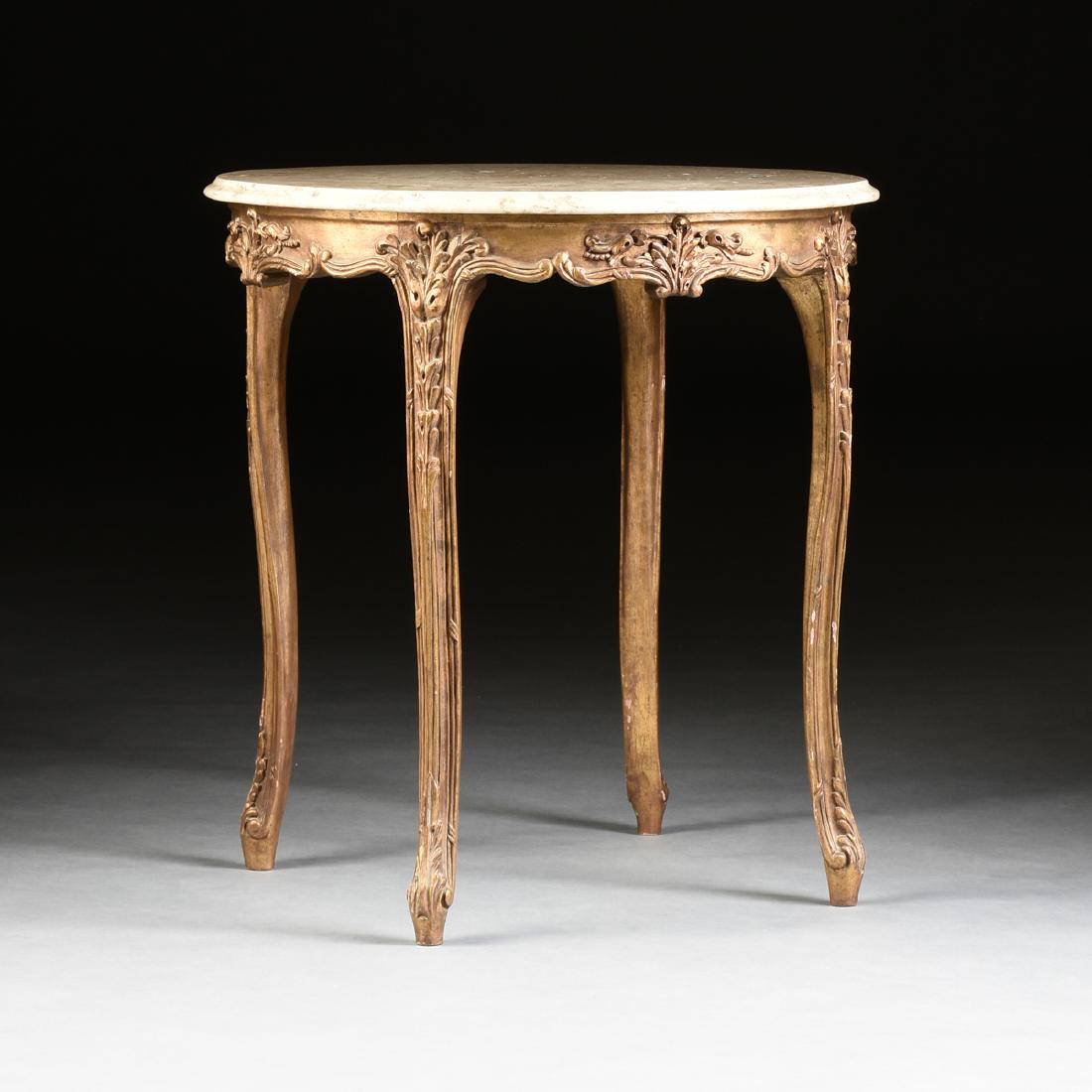 A ROCOCO REVIVAL GILTWOOD AND GESSO TRAVERTINE TOP: A ROCOCO REVIVAL GILTWOOD AND GESSO TRAVERTINE TOP GUÉRIDON, PROBABLY ITALIAN, MID 20TH CENTURY, the circular, molded edge top, over a serpentine, arched skirt with relief foliate sprays, raised on l