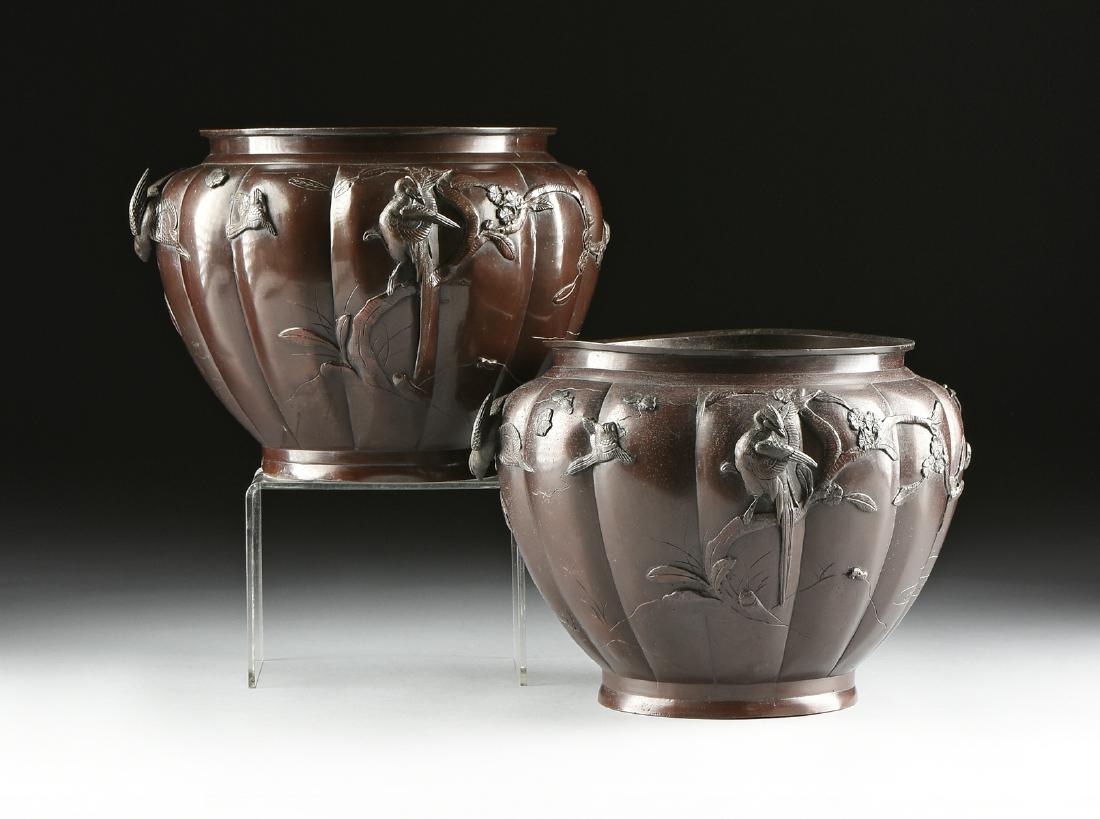 A PAIR OF JAPANESE PATINATED BRONZE JARDINIERES,: A PAIR OF JAPANESE PATINATED BRONZE JARDINIERES, SIGNED, MEIJI PERIOD, EARLY 20TH CENTURY, each of tapering circular form with lobed sides, enclosing applied and shallow relief cast birds amongst blos