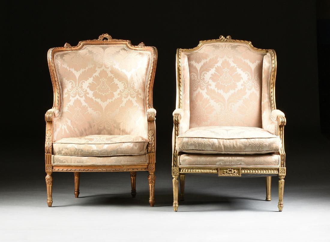 A MATCHED PAIR OF LOUIS XVI REVIVAL UPHOLSTERED: A MATCHED PAIR OF LOUIS XVI REVIVAL UPHOLSTERED GILTWOOD BERGÈRES À OREILLES, LATE 19TH/EARLY 20TH CENTURY, the larger bergère having a ribbon entwined rod carved "chapeau de gendarme" crest rail c