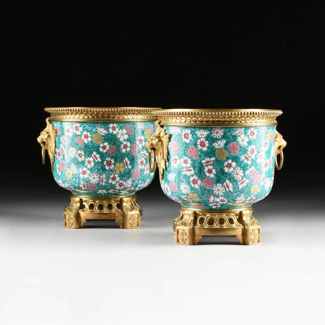 A PAIR OF LOUIS XVI STYLE GILT BRONZE MOUNTED AND: A PAIR OF LOUIS XVI STYLE GILT BRONZE MOUNTED AND POLYCHROME ENAMELED PORCELAIN CACHEPOTS, BRONZES BY HENRI PICARD, STAMPED AND NUMBERED, 19TH CENTURY, each of cylindrical form with a beaded and retic