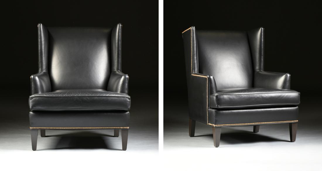 A PAIR OF ETHAN ALLEN BLACK LEATHER UPHOLSTERED: A PAIR OF ETHAN ALLEN BLACK LEATHER UPHOLSTERED "PARKER" WING BACK ARMCHAIRS WITH BRASS NAILHEAD TRIM, 2010, each of traditional wing back form with updated angular lines, raised on tapered stained wo