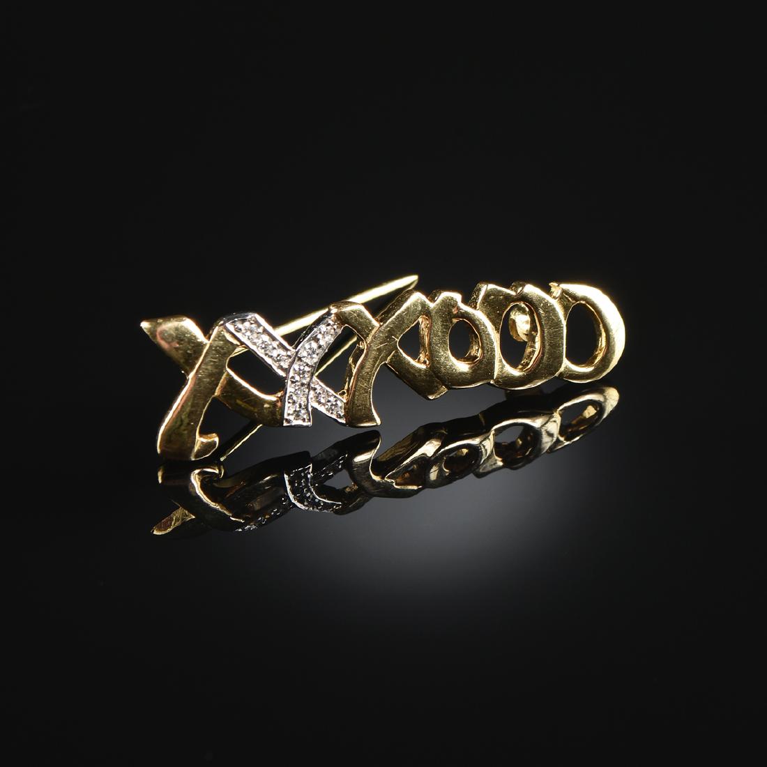 A TIFFANY & CO. PLATINUM 18K YELLOW GOLD AND DIAMOND: A TIFFANY & CO. PLATINUM 18K YELLOW GOLD AND DIAMOND "XO" BROOCH, DESIGNED BY PALOMA PICASSO, ten brilliant cut round diamonds, approximately .18 ctw, stamped. Width: 1 1/2"