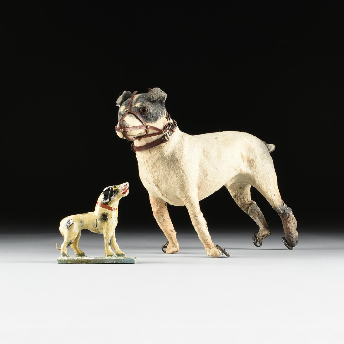 A GROUP OF TWO papier-mâché and wood CHILD'S TOYS IN: A GROUP OF TWO papier-mâché and wood CHILD'S TOYS IN THE FORM OF DOGS, 1900-1950, GERMAN AND EAST ORIENT, comprising a felt covered "Nipper" style terrier dog on wheels with muzzle and collar, 1900-