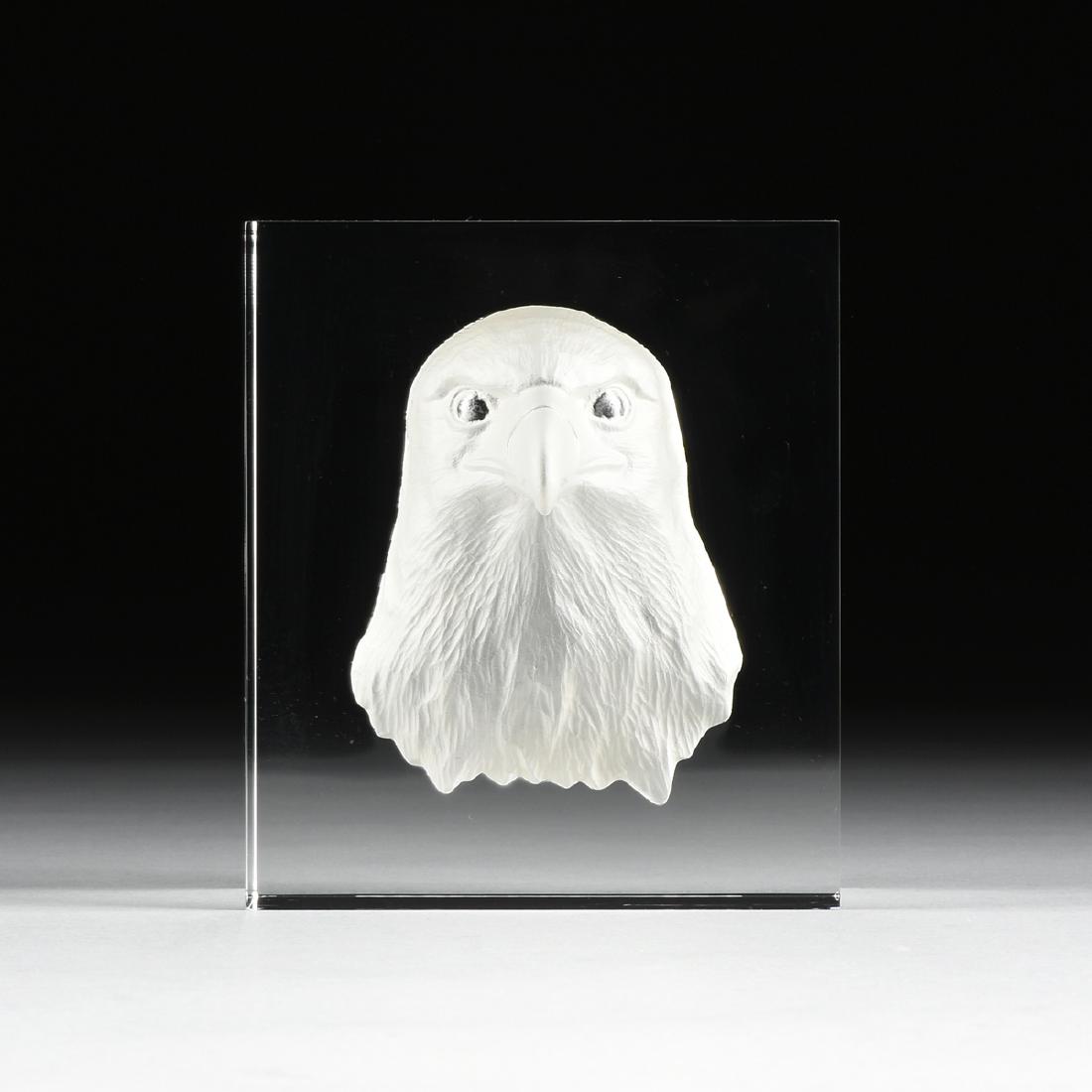 A STEUBEN GLASSWORKS INTAGLIO CUT AND PARTIAL FROSTED: A STEUBEN GLASSWORKS INTAGLIO CUT AND PARTIAL FROSTED CLEAR CRYSTAL SCULPTURE: "MAJESTIC EAGLE," CORNING, NEW YORK, CIRCA 1996, the solid block of clear crystal cut with the head of an American Eagle,