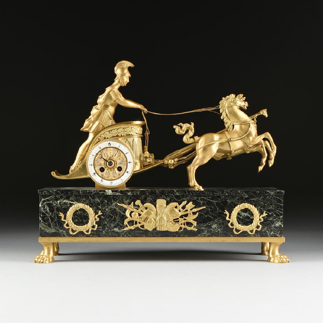 A MANTEL CLOCK, NEOCLASSICAL GILT BRONZE MOUNTED VERDE: A MANTEL CLOCK, NEOCLASSICAL GILT BRONZE MOUNTED VERDE ANTICO MARBLE, BY VINCENTI & CIE., FRENCH, 1855-1870, a figure of a Roman charioteer with medusa mask shield in his chariot, holding the reigns o