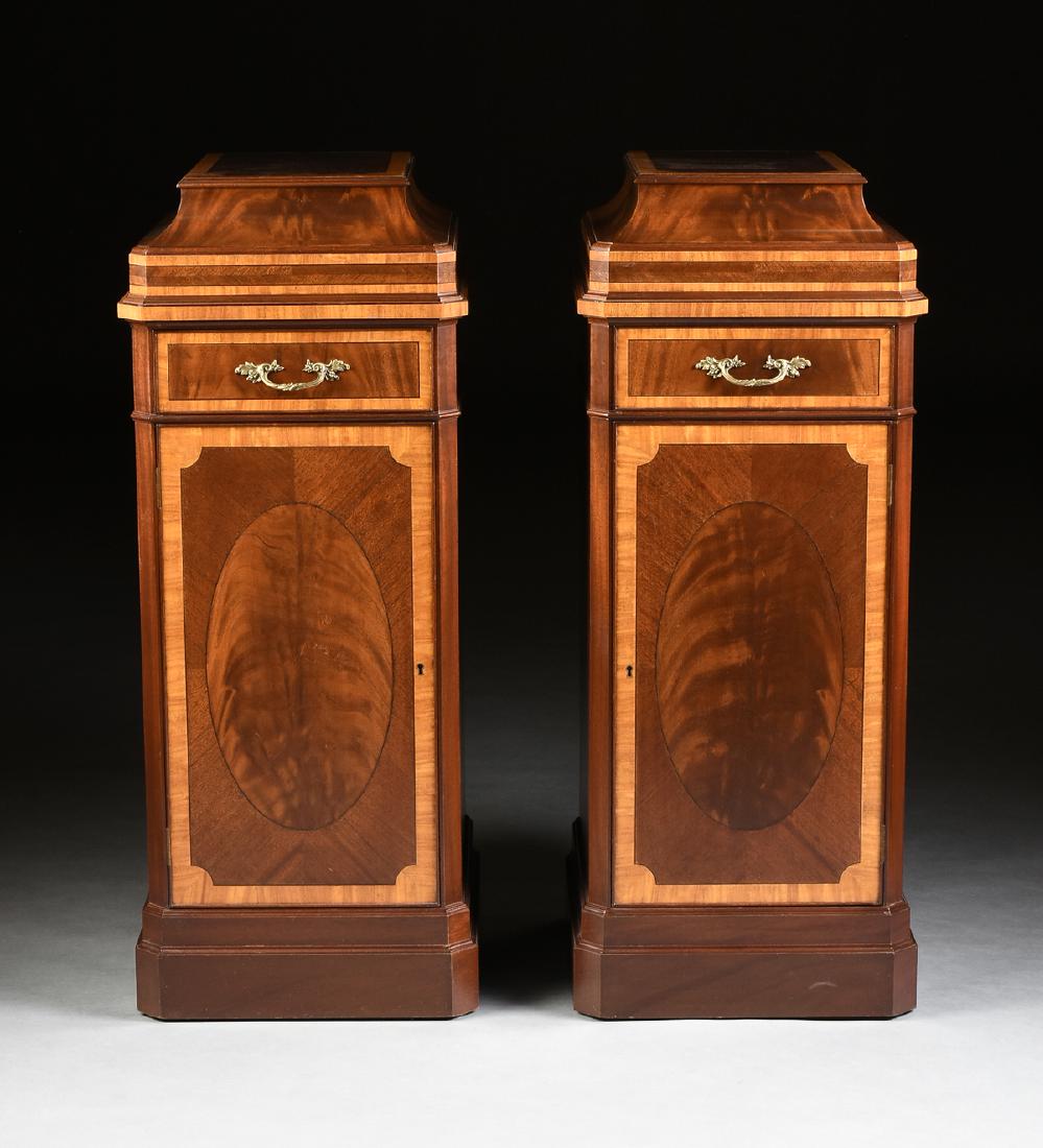 A PAIR OF REGENCY STYLE INLAID MAHOGANY PEDESTAL: A PAIR OF REGENCY STYLE INLAID MAHOGANY PEDESTAL CABINETS, GEORGE IV (1936-1952) PERIOD, each reproduction in the George III taste, of Neoclassical sarcophagus form, the rectangular top centering curl