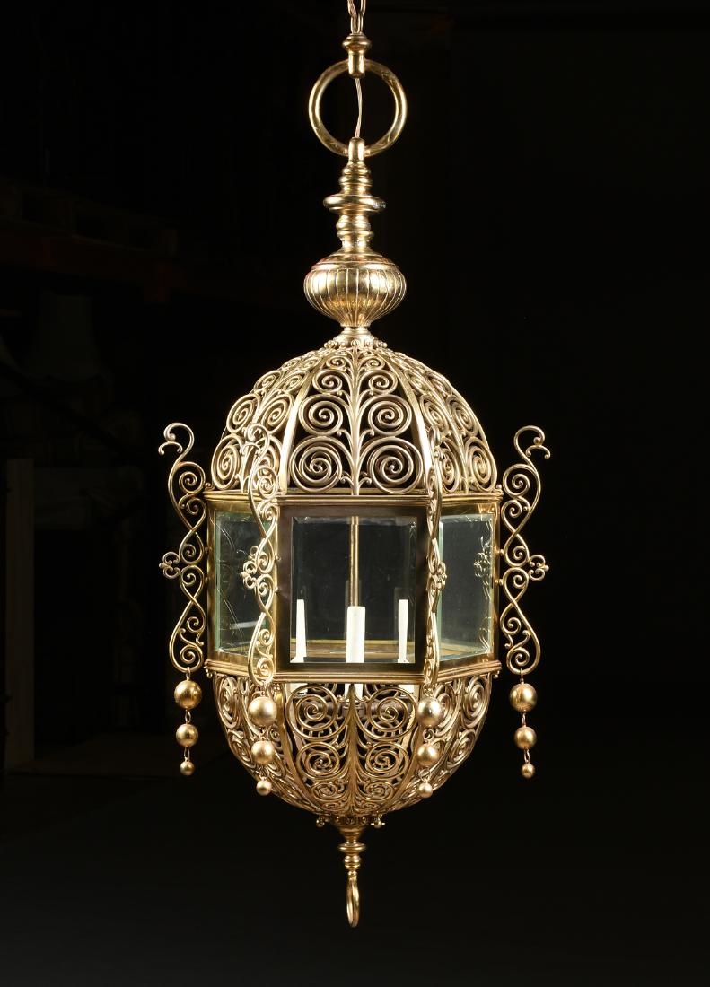 A LARGE ISLAMIC STYLE POLISHED BRASS AND BEVELED GLASS: A LARGE ISLAMIC STYLE POLISHED BRASS AND BEVELED GLASS LANTERN, SECOND HALF 19TH CENTURY, the circular loop and reeded bun form stem, suspending a reticulated dome of stylized scrolling foliage and a 