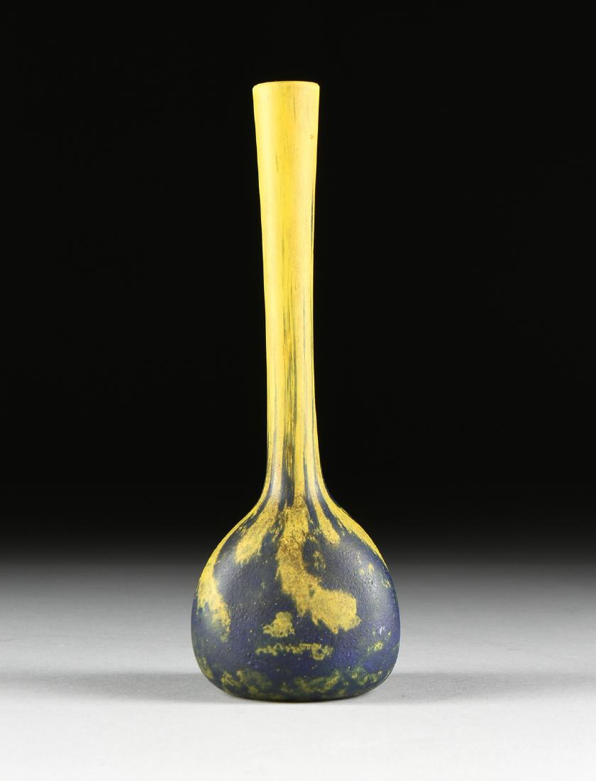 A FRENCH ART DECO MOTTLED GLASS VASE, BY ANDRÉ DELATTE,: A FRENCH ART DECO MOTTLED GLASS VASE, BY ANDRÉ DELATTE, SIGNED, NANCY, 1920s, the long slender neck enameled in yellow and dark blue streaks ending in mottled puddles on the three sided bulbous body,
