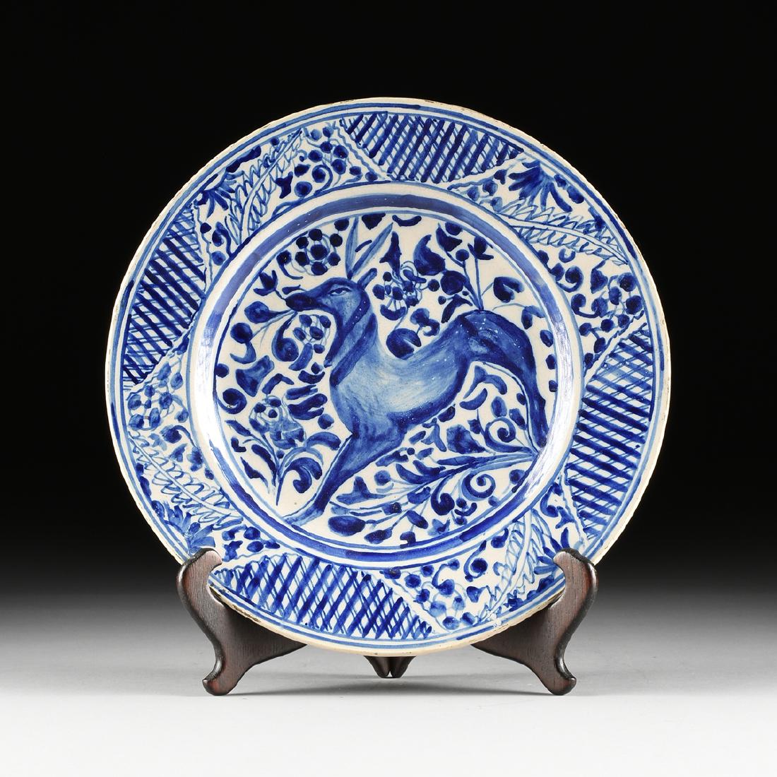 A DELFT BLUE GLAZED EARTHENWARE CHARGER, DUTCH,: A DELFT BLUE GLAZED EARTHENWARE CHARGER, DUTCH, 18TH/19TH CENTURY, blue underglaze paint decoration of stag within profuse foliate and lattice motif. Diameter: 16.125"