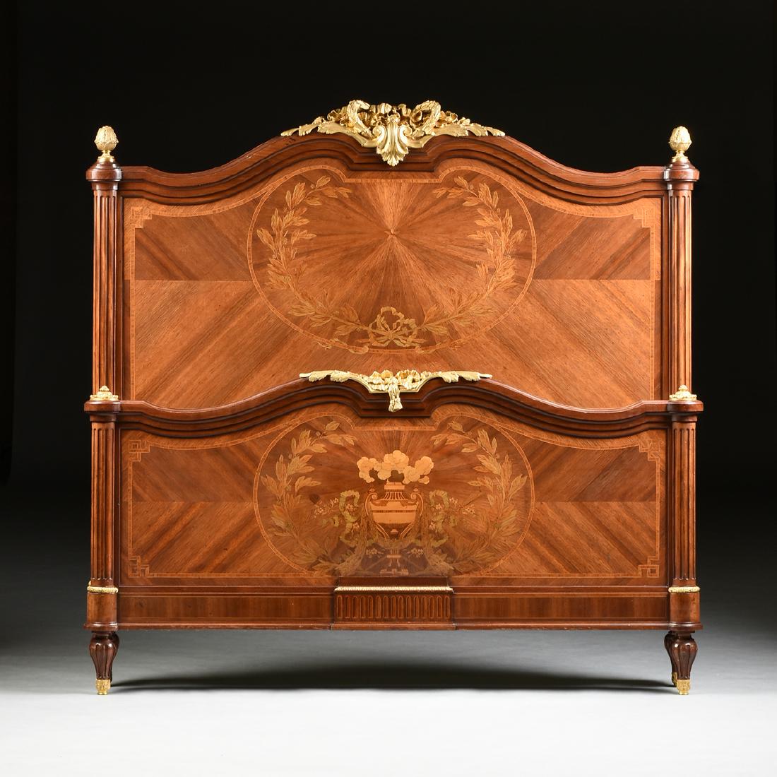 A FINE LOUIS XVI STYLE ORMOLU MOUNTED TULIPWOOD AND: A FINE LOUIS XVI STYLE ORMOLU MOUNTED TULIPWOOD AND VARIOUS WOODS INLAID MARQUETRY BED, SIGNED, LATE 19TH/EARLY 20TH CENTURY, the double arched crest rail centering a nicely cast and chased gilt bronz