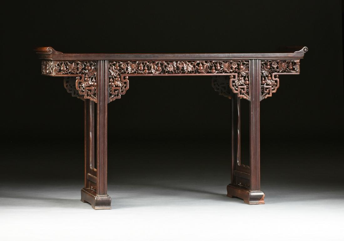 A CHINESE CARVED HARDWOOD ALTAR TABLE, LATE 19TH: A CHINESE CARVED HARDWOOD ALTAR TABLE, LATE 19TH/EARLY 20TH CENTURY, in the Ming style, with a rectangular top with scrolled ends, above a pierced frieze of fruiting double gourd and blossoming leafy
