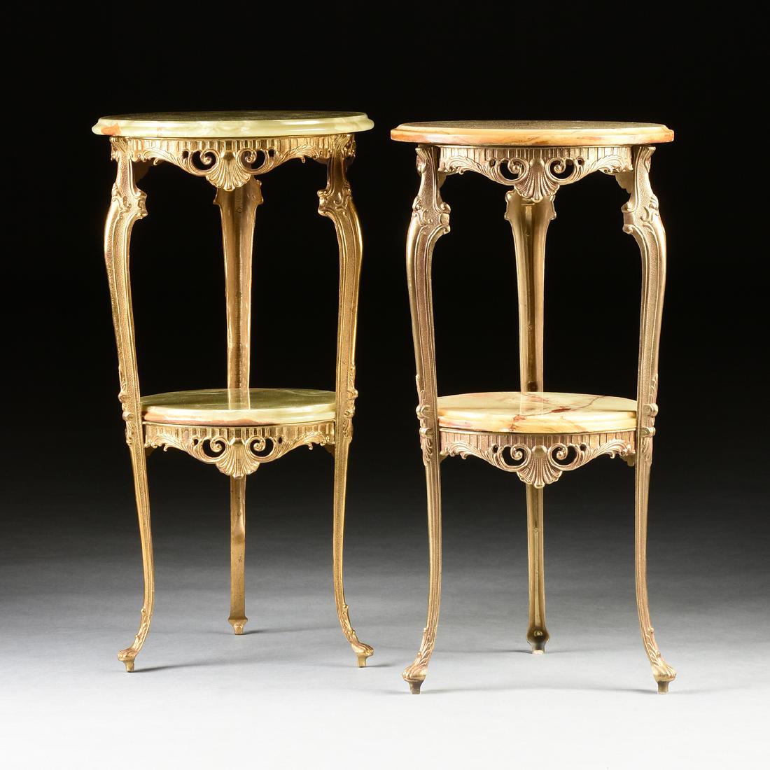 A NEAR PAIR OF ROCOCO REVIVAL STYLE GILT METAL AND ONYX: A NEAR PAIR OF ROCOCO REVIVAL STYLE GILT METAL AND ONYX TOP GUÉRIDON TABLES, MODERN, the circular tops fitted with molded edge circular, polished onyx tops, over pierced, arched skirts with relief sh