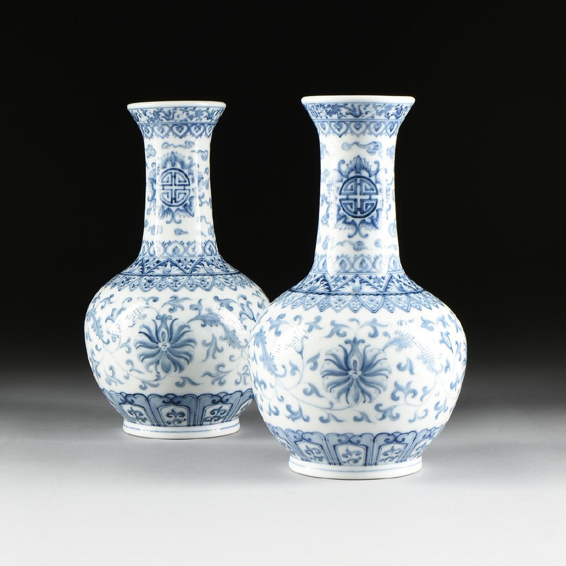 A PAIR OF CHINESE BLUE AND WHITE PORCELAIN VASES, BLUE: A PAIR OF CHINESE BLUE AND WHITE PORCELAIN VASES, BLUE SQUARE MARK, MODERN, each of bottle form and decorated in underglaze blue with shou symbols, bats and stylized lotus blooms, above an underside c