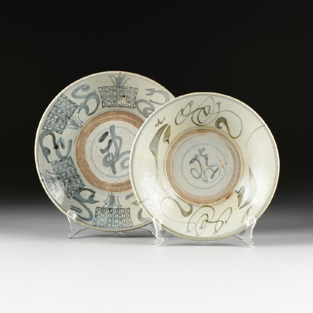 TWO CHINESE SWATOW WARE UNDERGLAZE SLIP PAINTED SEMI: TWO CHINESE SWATOW WARE UNDERGLAZE SLIP PAINTED SEMI GLAZED PLANTER SAUCERS, IN THE MING DYNASTY (1368-1644) TASTE, the largest example with blue/black underglaze slip painted decoration of plants gro
