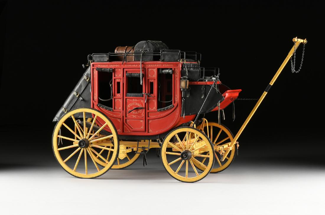 DALE FORD (American b. 1934) AN ORIGINAL HAND PAINTED: DALE FORD (American b. 1934) AN ORIGINAL HAND PAINTED MODEL OF A WELLS FARGO & CO BUTTERFIELD OVERLAND STAGECOACH, the red painted coach is signed and inscribed, "WELLS FARGO & CO OVERLAND STAGE," and