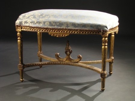 A LOUIS XVI STYLE GILTWOOD BANQUETTE, the shaped r
