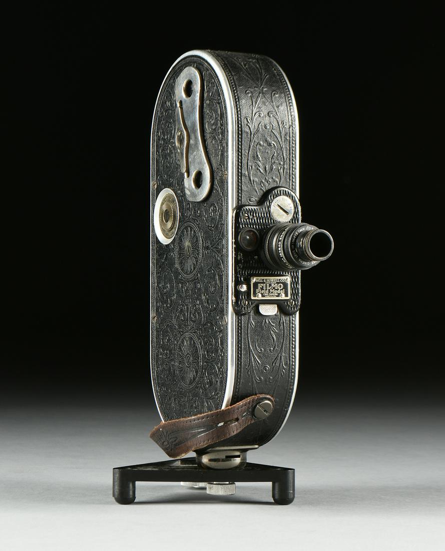 AN ANTIQUE AMERICAN BELL AND HOWELL "FILMO FIELD MODEL": AN ANTIQUE AMERICAN BELL AND HOWELL "FILMO FIELD MODEL" AUTOMATIC CINE-CAMERA, CHICAGO, 1928-1933, 20mm, mounted with a Taylor Hobson Cooke Cinema Lens No. 186473. Height: 10" Diameter: 6"