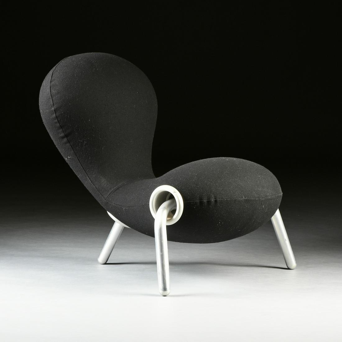 MARC NEWSON (AUSTRALIAN b.1963) A BLACK UPHOLSTERED: MARC NEWSON (AUSTRALIAN b. 1963) A BLACK UPHOLSTERED ALUMINUM CHAIR, "Embryo," the biomorphic amoeba shaped chair covered in black upholstery and raised on three aluminum legs. Height: 31" Width: 32"