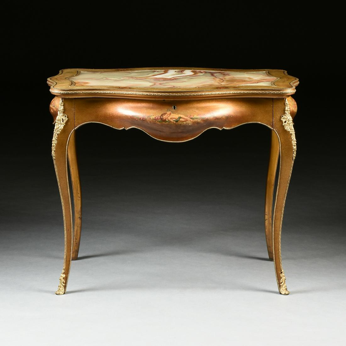 A ROCOCO REVIVAL ONYX AND GILT BRONZE MOUNTED HAND: A ROCOCO REVIVAL ONYX AND GILT BRONZE MOUNTED HAND PAINTED BUREAU PLAT, AMERICAN, MOUNTS BY P.E. GUERIN, CIRCA 1890, the serpentine rectangular top centering an inset cream and honey amber veined onyx