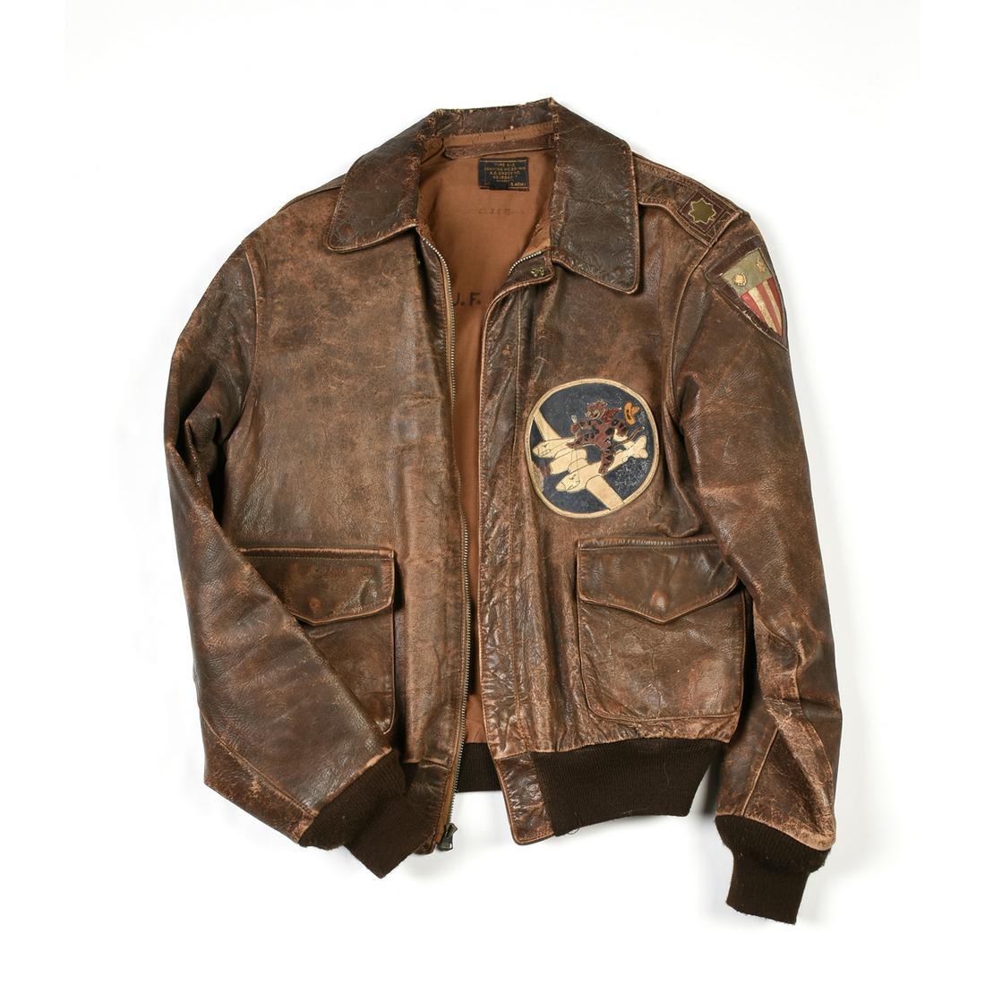 A WORLD WAR II BROWN HORSEHIDE FLYING TIGER A2 JACKET,: A WORLD WAR II BROWN HORSEHIDE FLYING TIGER A2 JACKET, the worn brown leather jacket with left front Flying Tiger patch and left arm China Burma India shield patch, right arm circular patch centering