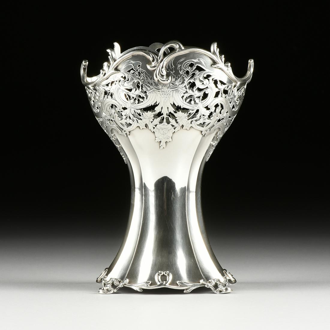 A GEORGE V STERLING SILVER VASE, HALLMARKED, WILLIAM: A GEORGE V STERLING SILVER VASE, HALLMARKED, WILLIAM COMYNS, LONDON, 1912, in the Rococo Revival taste and of shaped oval form with a waisted body flaring to a reticulated border of engraved scrolling