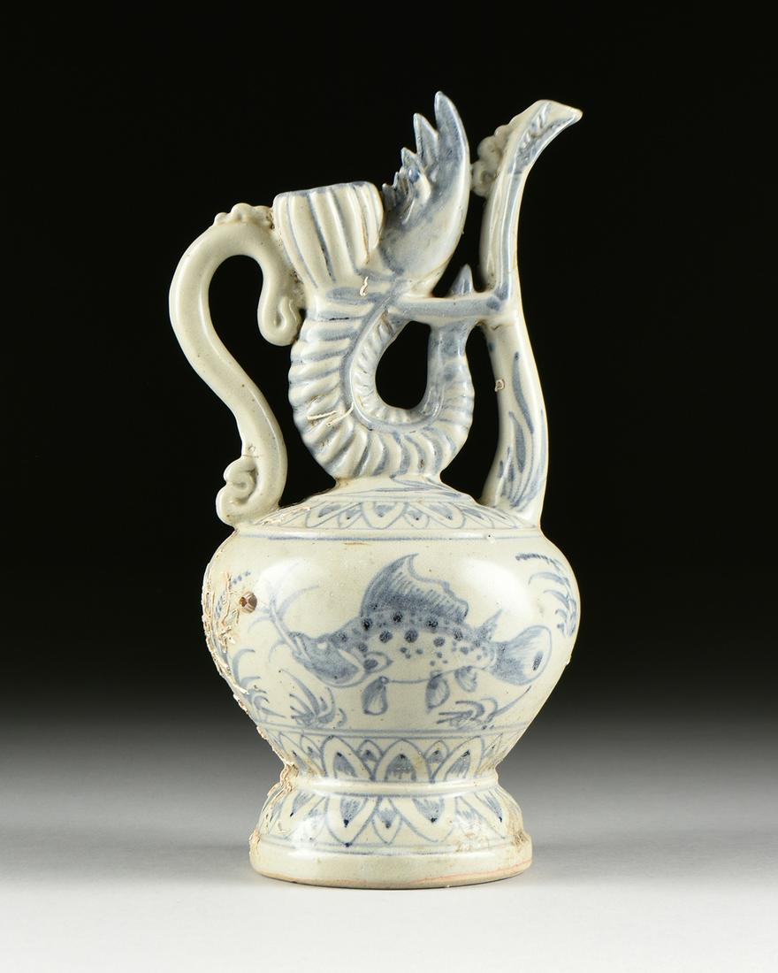 AN UNUSUAL VIETNAMESE/ANNAMESE BLUE AND WHITE PAINTED: AN UNUSUAL VIETNAMESE/ANNAMESE BLUE AND WHITE PAINTED MANTIS SHRIMP MODELED EWER, SHIPWRECK ARTIFACT, 15TH/16TH CENTURY, with a bulbous body and sides centering native carp swimming amidst marine foli