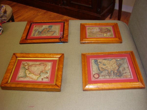 A GROUP OF FOUR CONTINENTAL HAND COLORED TOPOGRAPH: A GROUP OF FOUR CONTINENTAL HAND COLORED TOPOGRAPHICAL MAPS, each depicting an European region or Asia, with Latin descriptions, 18th/19th centuries, within a rectangular burl maple frame. Height: 5 1