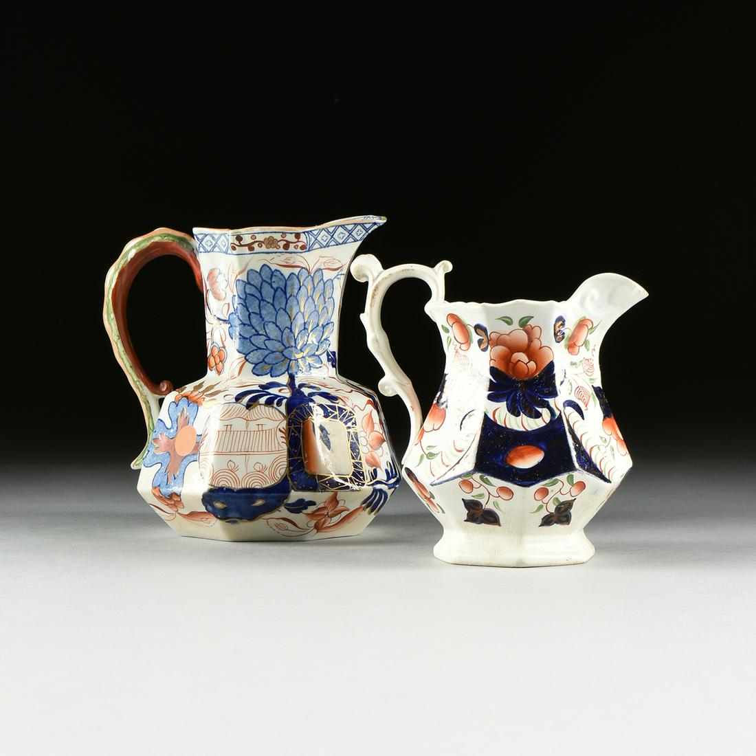A GROUP OF TWO ENGLISH IMARI STYLE IRONSTONE PITCHERS,: A GROUP OF TWO ENGLISH IMARI STYLE IRONSTONE PITCHERS, 19TH CENTURY, the larger example with blue underglaze floral motif with iron red and parcel gilt decoration, the handle in a green reptilian scal