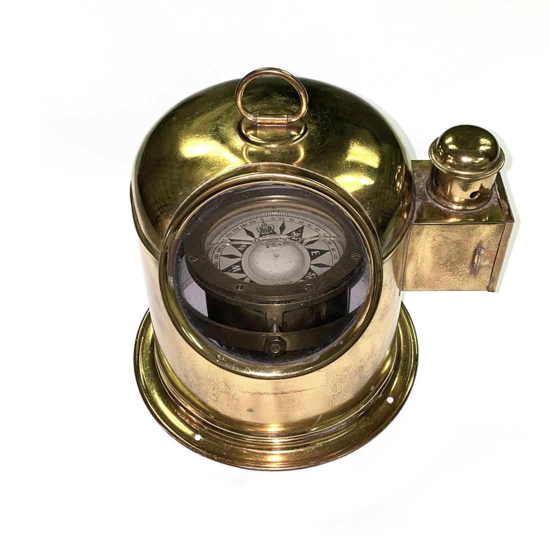 AN ITALIAN BRASS YACHT BINNACLE AND COMPASS, BY: AN ITALIAN BRASS YACHT BINNACLE AND COMPASS, BY SALMIERI, GENOA, EARLY 20TH CENTURY, the circular double suspended liquid compass within a domed brass binnacle fitted with handle and side light box, c