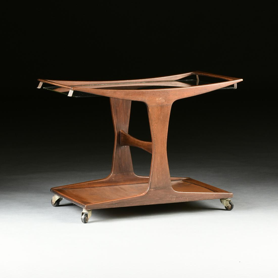 SVANTE SKOGH (Swedish active 1950-1960) A MID CENTURY: SVANTE SKOGH (Swedish active 1950-1960) A MID CENTURY MODERN ROSEWOOD GLASS TOP CART TABLE, SWEDEN AND COLOMBIA, the curved top fitted with a recessed glass top, raised on two tapered supports joined