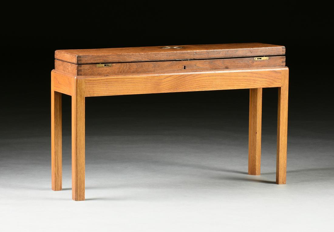 A GEORGE III MAHOGANY GUN CASE ON LATER STAND, LATE: A GEORGE III MAHOGANY GUN CASE ON LATER STAND, LATE 18TH/EARLY 19TH CENTURY. the long rectangular hinged lid centering an inset bronze circular disc with recessed semi circular pull, opening to a worn