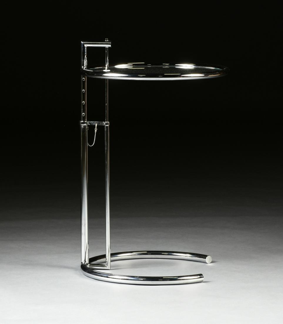 AN EILEEN GRAY ADJUSTABLE GLASS AND CHROME CIRCULAR: AN EILEEN GRAY ADJUSTABLE GLASS AND CHROME CIRCULAR SIDE TABLE, MODEL NUMBER 1027, 1960s/1970s, the circular chromed metal tubular frame top centering a conforming glass panel, on a rectangular adjust