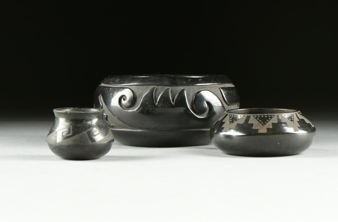 A GROUP OF THREE NATIVE AMERICAN PUEBLO BLACK POTTERY: A GROUP OF THREE NATIVE AMERICAN PUEBLO BLACK POTTERY WARES, BY TERESITA NARANJO AND JUANITA GONZALEZ, SANTA CLARA AND SAN ILDEFONSO PUEBLOS, NEW MEXICO, SIGNED, CIRCA 1960, comprising a carved black