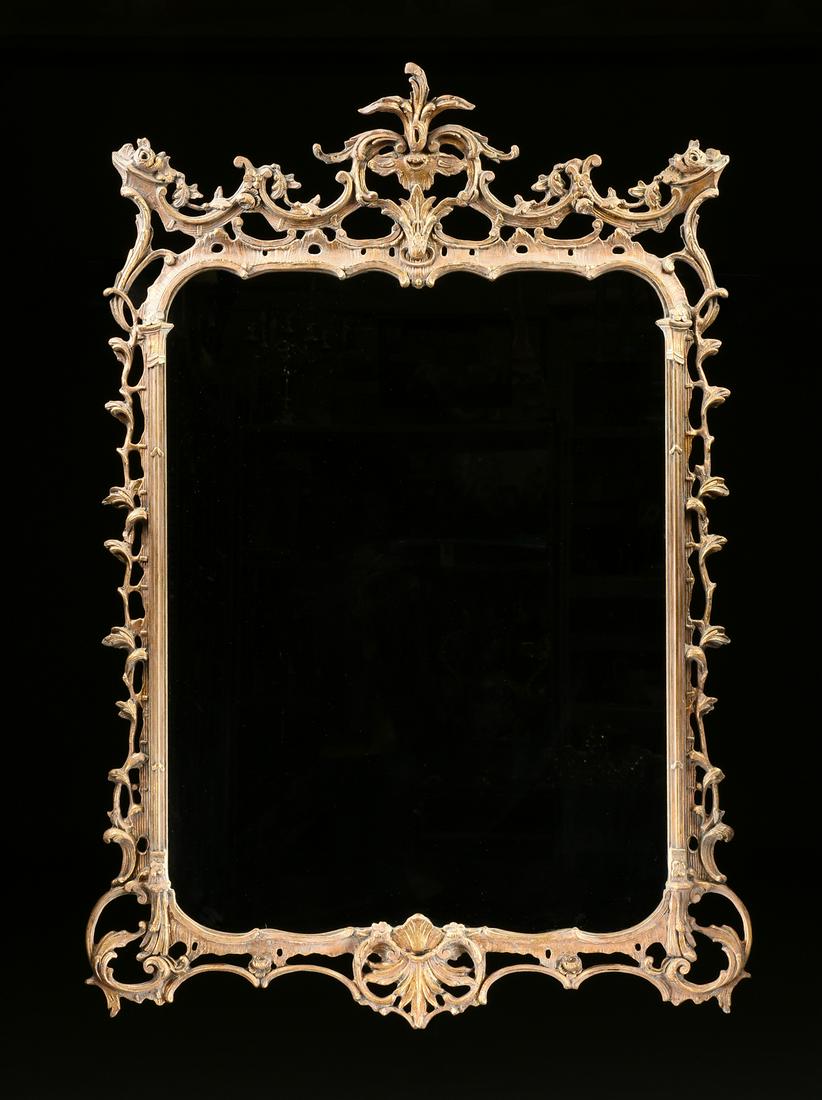 A GEORGE III ROCOCO STYLE PARCEL GILT COMPOSITE: A GEORGE III ROCOCO STYLE PARCEL GILT COMPOSITE MIRROR, MODERN, the crest with a central acanthus plume within pierced "C" scroll swag hung by rose bud ears, over moss growth upheld by engaged Arcadia