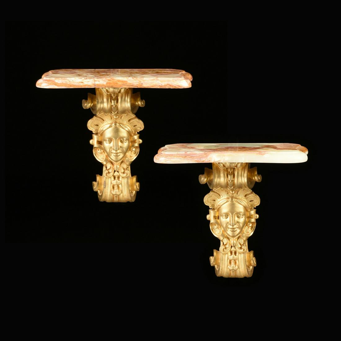 A PAIR OF LOUIS XIV STYLE GILT BRONZE AND ONYX WALL: A PAIR OF LOUIS XIV STYLE GILT BRONZE AND ONYX WALL BRACKET SHELVES, EARLY 20TH CENTURY, each serpentine rectangular polished rouge onyx top raised on "S" scrolled volutes with wrapped ribbon and bell